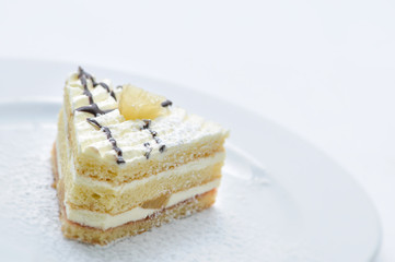 cream cake with powder sugar,pineapple and topping on white plate, sweet dessert, product photography for patisserie or shop