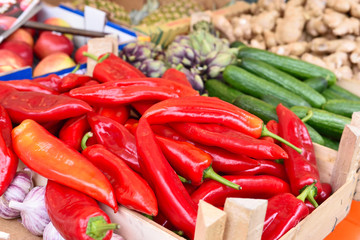 Fruit market with various fruits and vegetables. Fresh vegetables and fruits at a market stall. Colorful vegetable and fruits in a row with copy space. Pointed pepper in the foreground.