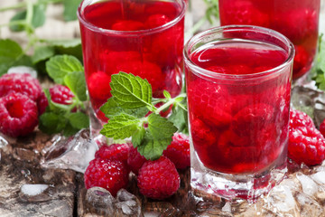 Refreshing raspberry drink with berries, ice and mint, selective
