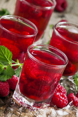 Refreshing raspberry drink with berries, ice and mint, selective