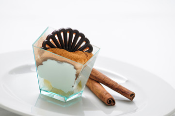 tiramisu in taster with cocoa powder and coffee beans on white plate, italian desserts, patisserie,...