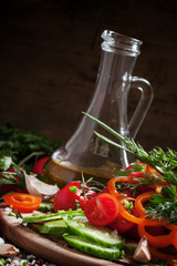 Cut fresh vegetables, spices and olive oil for a spring salad, h