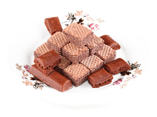 Chocolate wafers and airy milk chocolate pieces arranged on a plate