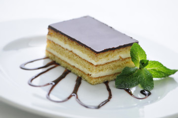 sponge cake with vanilla cream and topping on white plate, sweet dessert, patisserie, photography for shop