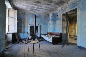 Old abandoned blue room with couch and chair