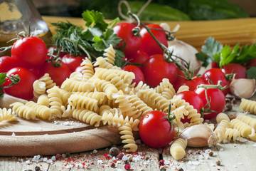 Dry Italian pasta spiraline with cherry tomatoes, parsley, garli