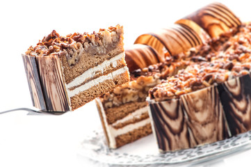 Birthday chocolate cake with nuts and chocolate decoration, piece of cream cake, patisserie, photography for shop, sweet dessert