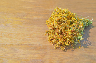 Hypericum perforatum or St John's wort. St.  Hypericum  dried  on a wooden table