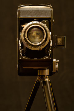 Old camera on tripod. Clipping path.