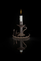 reflected candle on black background