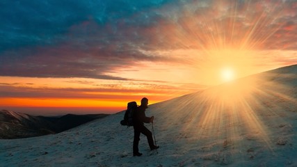 Fototapeta na wymiar A man in mountain sunset winter