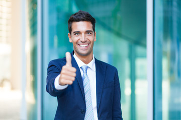 Young man doing thumbs up sign