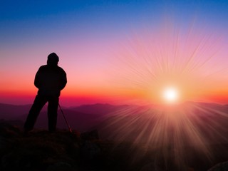 A man in mountain sunset autumn