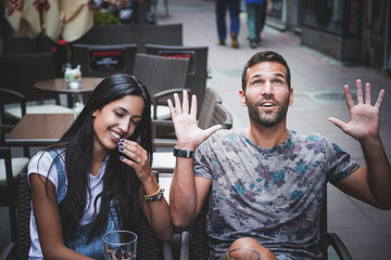 Couple laughing in a bar
