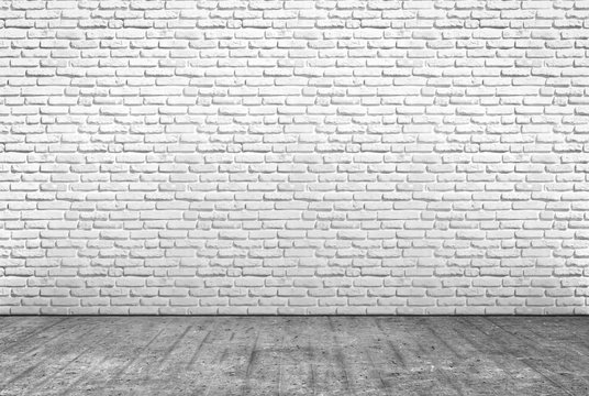 pavimento in cemento e muro in mattoni bianchi
