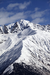 Fototapeta na wymiar Snowy mountain peak at sunny day