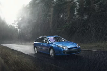 Papier Peint photo Lavable Voitures rapides Blue car fast drive on wet road in rain at daytime