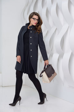 Girl in studio posing at coat