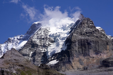 Fototapeta premium Swiss mountain summit: Jungfrau wrapped in clouds