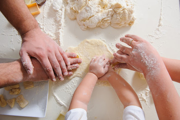 Hands adult, child cook cookies in kitchen closeup - obrazy, fototapety, plakaty