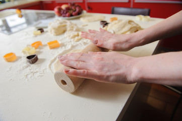 Closeup of woman hand with rolling baking cookies
