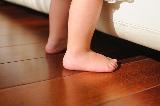 Children's bare feet, beside to bed