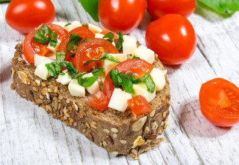 Ciabatta bread with tomatoes, mozzarella and basil.