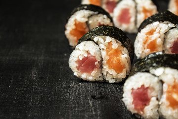 Rolls Yin-Yang with tuna and salmon on a black background