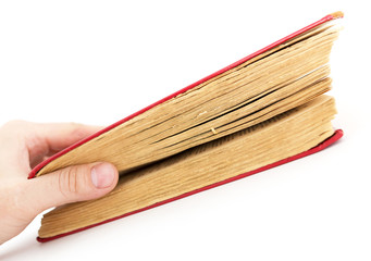 old book in his hand on a white background