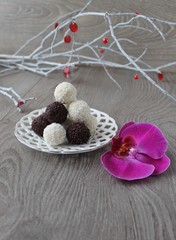 black and white truffles of chocolate and coconut topping. Homemade candy.