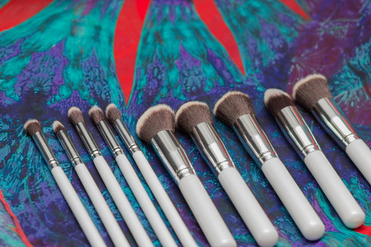 set of brushes for makeup on boho background