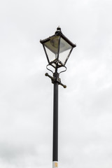 Fototapeta na wymiar Old-fashioned street lamp against the sky. Cashel, Ireland.