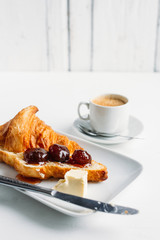 Breakfast with coffee, croissant and strawberry jam