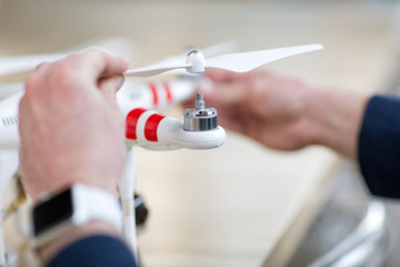 Skillful male freelancer is repairing a drone