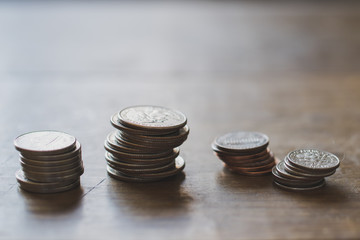 Stacks of US Coin Denominations on Wooden Table