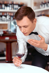 Professional sommelier tasting wine 