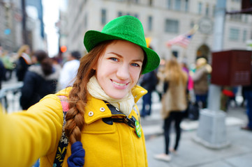 Young tourist taking a selfie during the annual St. Patrick's Day Parade in New York
