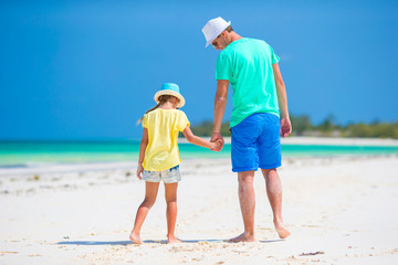 Little girl and young father during tropical beach vacation