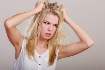 Angry mad woman furious girl pulling messy hair