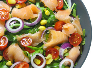 Salad with arugula, tomatoes, corn, smoked salmon and red onion