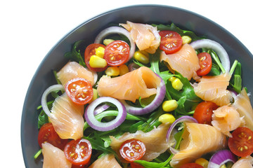 Salad with arugula, tomatoes, corn, smoked salmon and red onion
