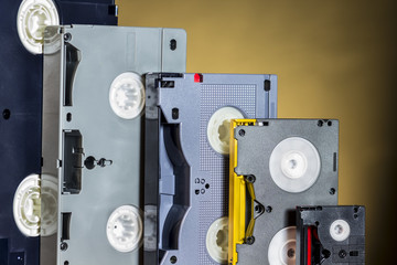 Analog and digital video tapes, on orange background