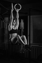 Fit young woman on gymnast rings
