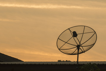black and  dark satellite dishes sky gokd background on roof