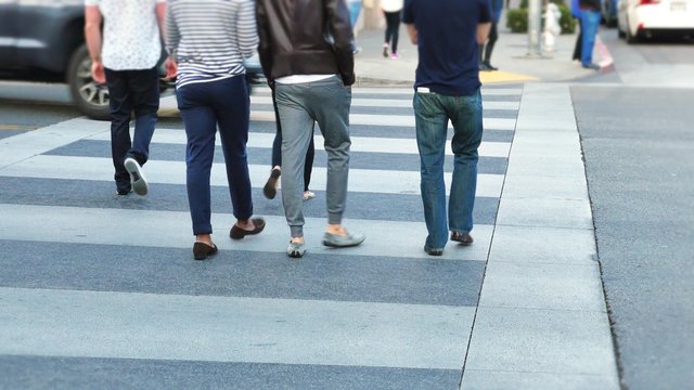People walking in a crosswalk on Rodeo Drive in Beverly Hills.  	