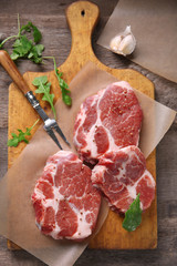 Marbled beef steak and spices on wooden background