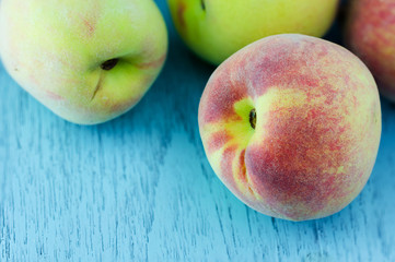 group of fresh peaches on wood background