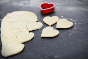 Fototapeta na wymiar Uncooked heart shaped biscuits on a table