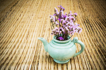 Obraz na płótnie Canvas Vintage kettle with dry bouquet on nature background.
