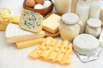 Set of fresh dairy products on white wooden table